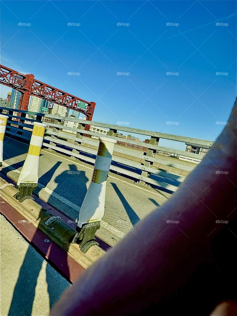This is an accidental shot that turned out to be quite interesting composition wise nonetheless. The streamlined architecture of the “Pulaski Bridge” merges nicely with the curved elongated shadow of myself. 2023. Hypnotic Productions
