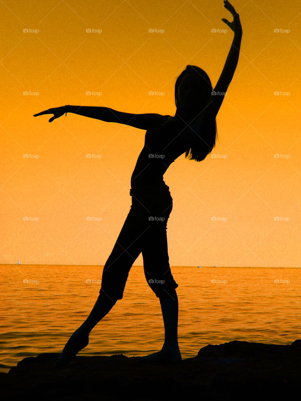 Silhouette of female dancer against sky