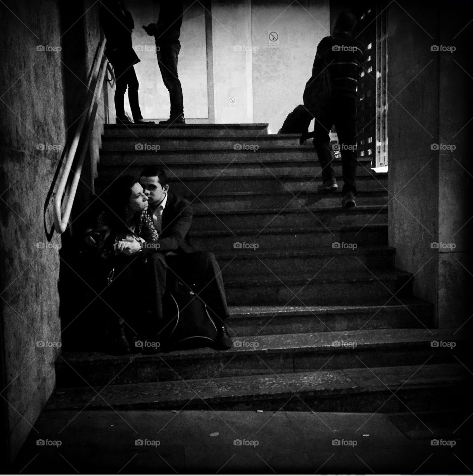 Passionate couple dating on stairs at night 