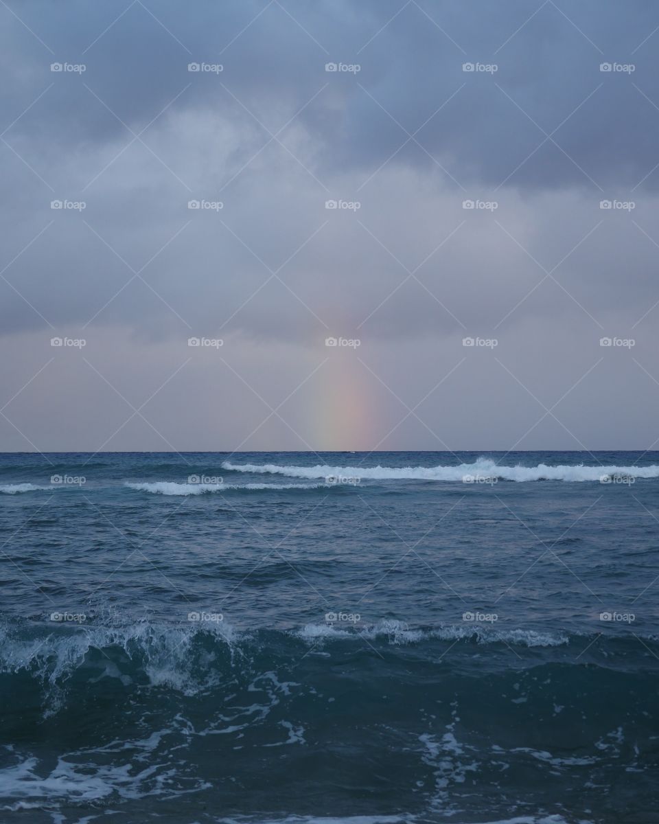 Rainbow in the middle of an ocean 