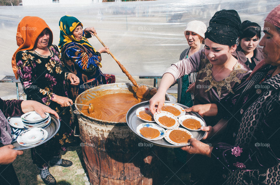 Women are cooking sumalak for spring festival Nowruz
