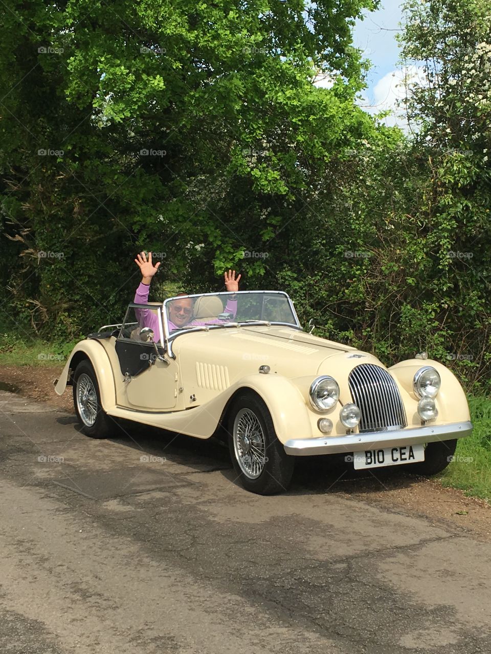 Happy mature man sitting in vintage car