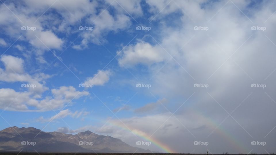 Storm clouds and a rainbow in a landscape view