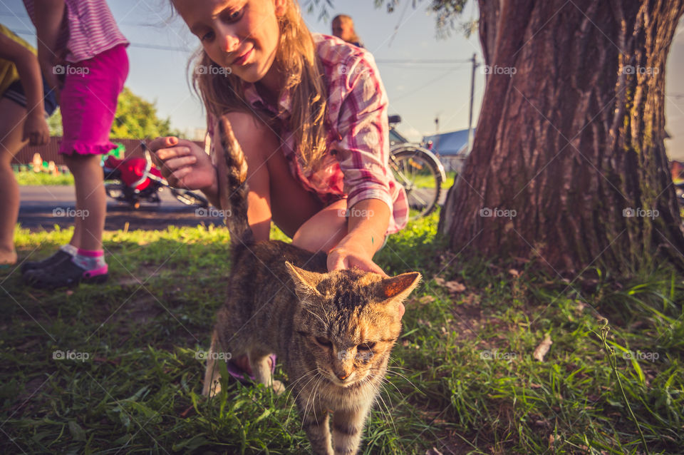 Girl and cat on the street