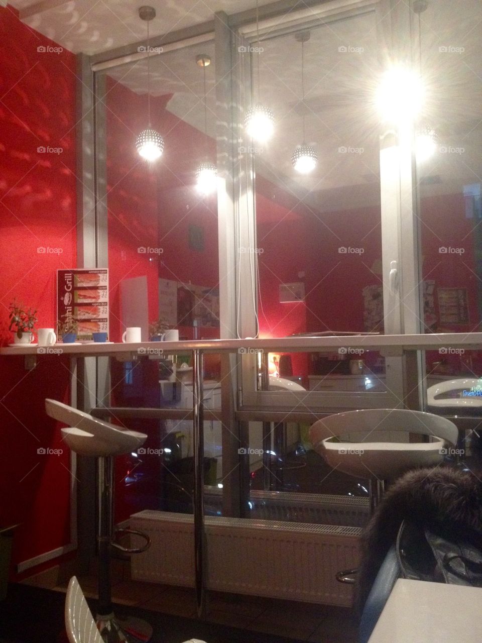 Table and chairs in front of a window in the working space in the evening