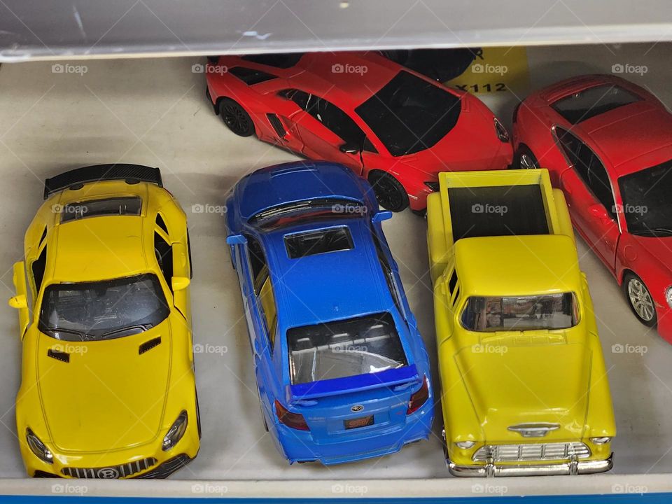 brightly colored toy cars on a store shelf