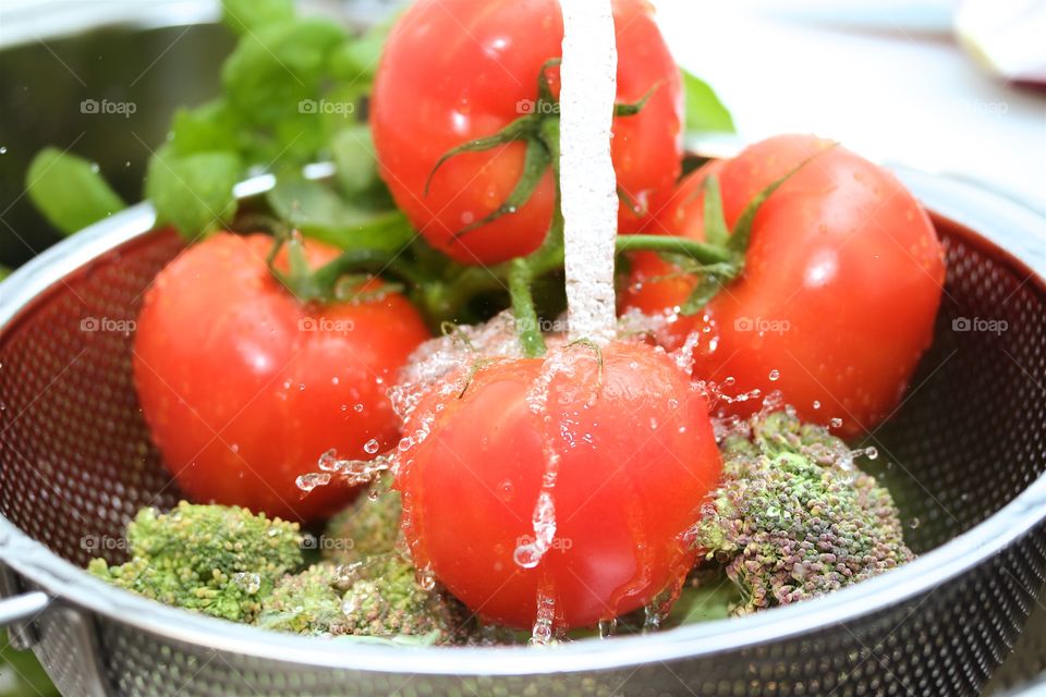 Vegetables being washed in sink