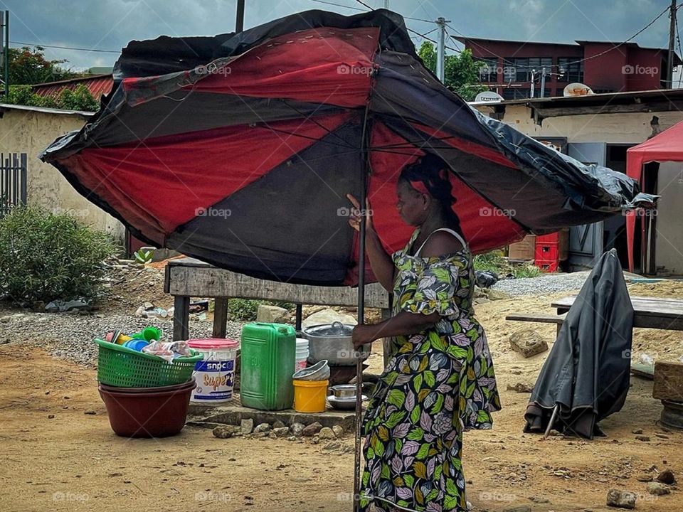 Women holding her umbrella.