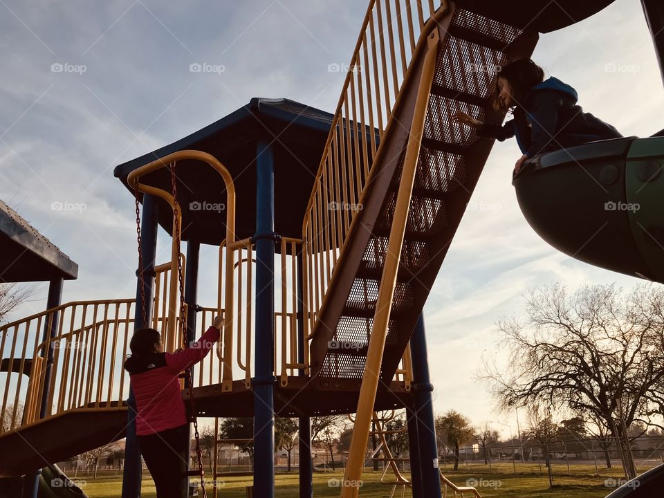 The girls were having fun at the  Playground after school in the afternoon 