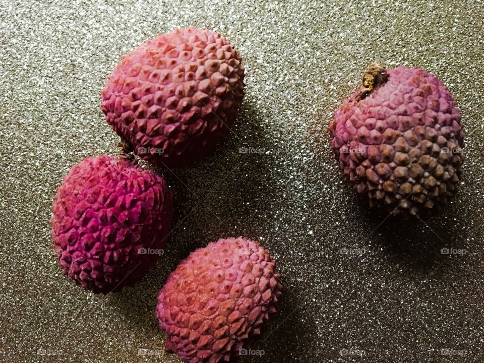 Four lychees enjoying the prime spot