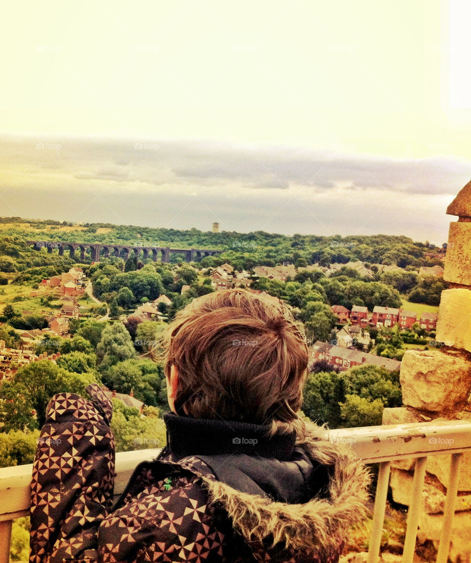 Boy looking out from top of Castle