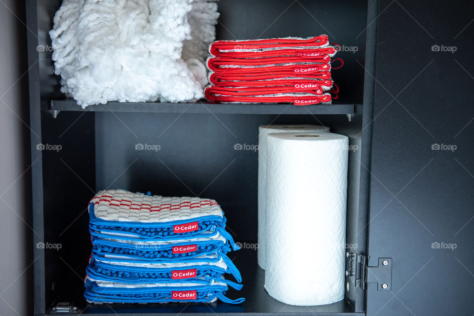 O-Cedar microfiber mop head refills stored in a cabinet