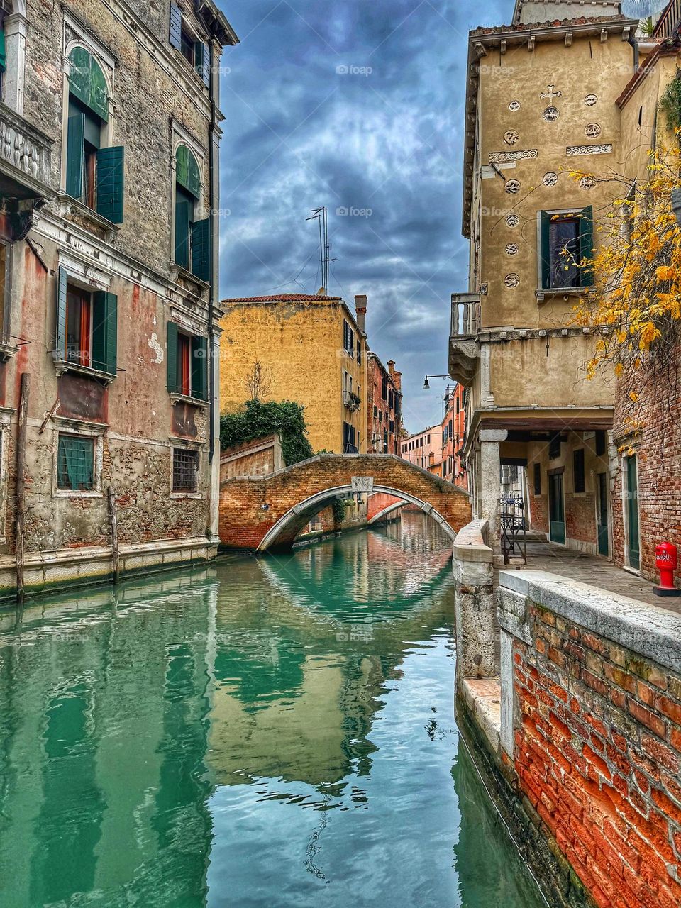 Water reflection of colorful house and bridge 