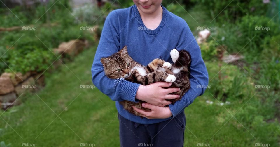 boy holding a cat