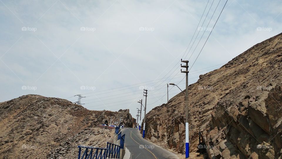 Climbing a rock hill in the district of Lima, Peru. The hill is steep, but the tourists who go to Lima visit it.