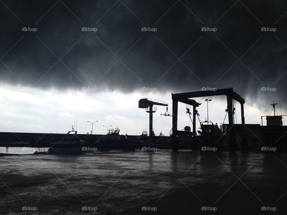 dark clouds storm in the traveling crane harbor