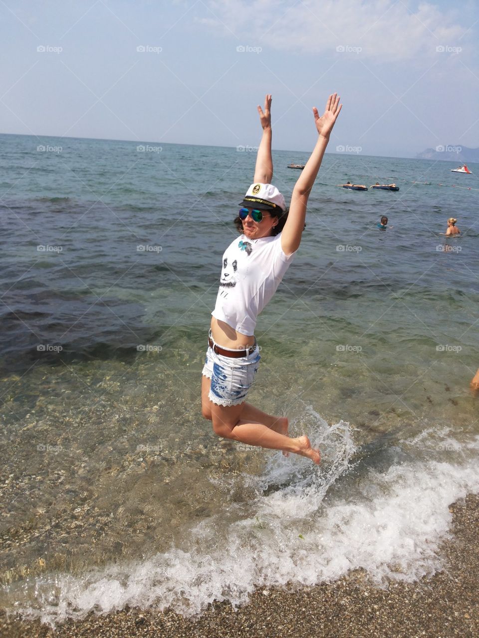 happy girl jumps the sea