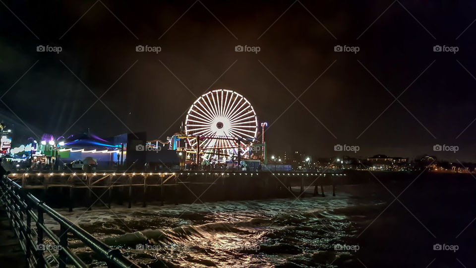 The brightly lit wheel at Santa Monica Pier in Los Angeles, California.