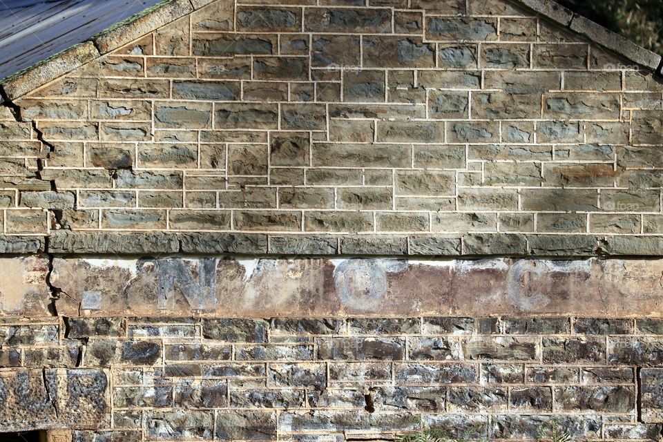 150 year old brick wall from ruin, with old rusted sign, background image, South Australia 