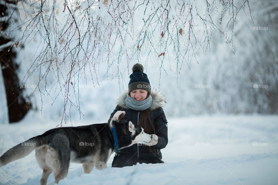 Walking with husky in winter park