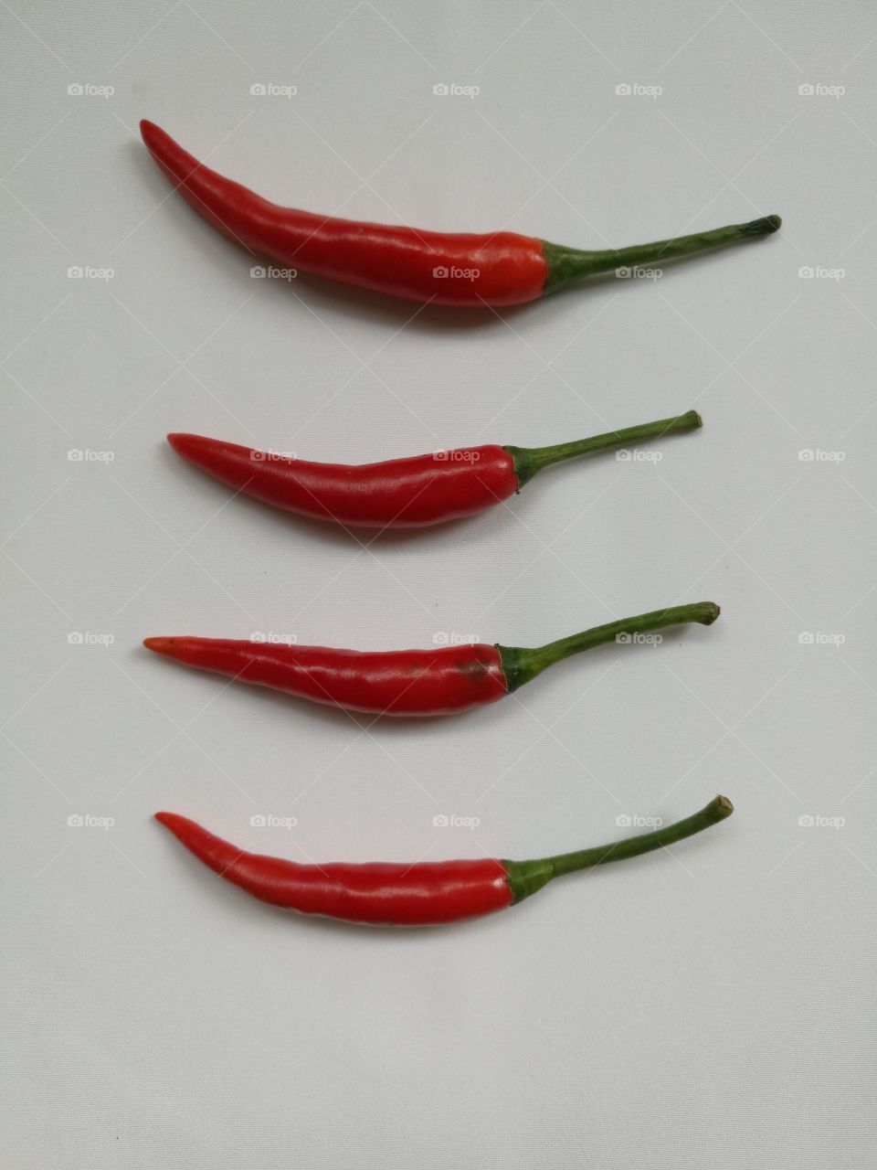 Top view of fresh red chilli peppers isolated on white background.