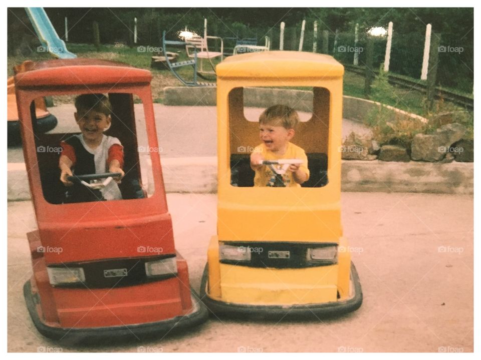 Vintage old photo of my two sons in stitches as they bump into each other on purpose .. photo quality is very poor ..  no digital in the 90’s 😂