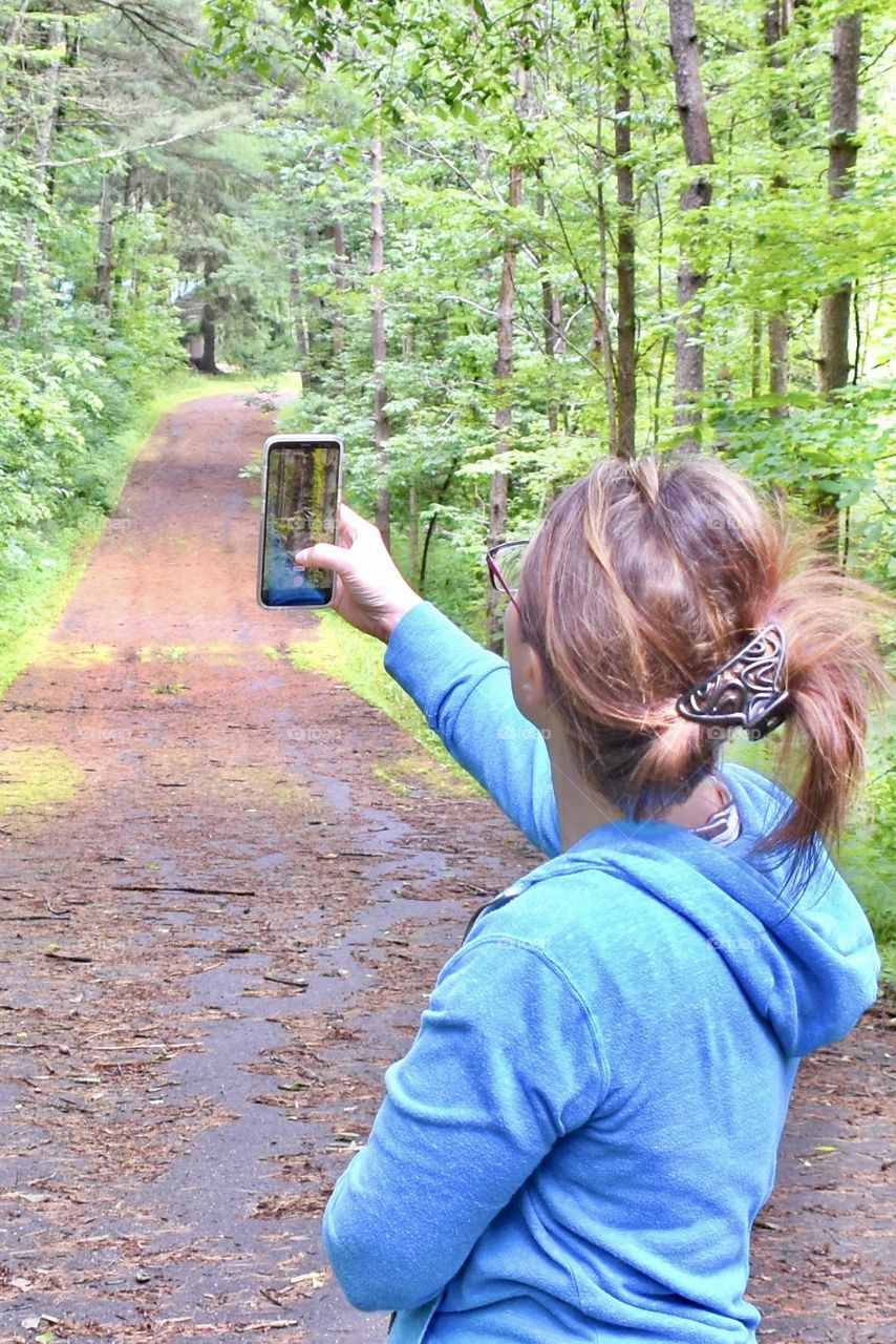 Woman taking a photo with her cell phone 