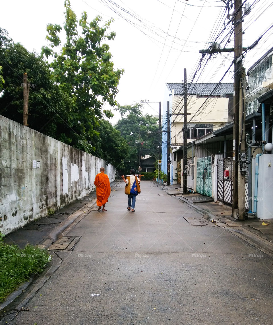 monk  ask for alms with his attendant