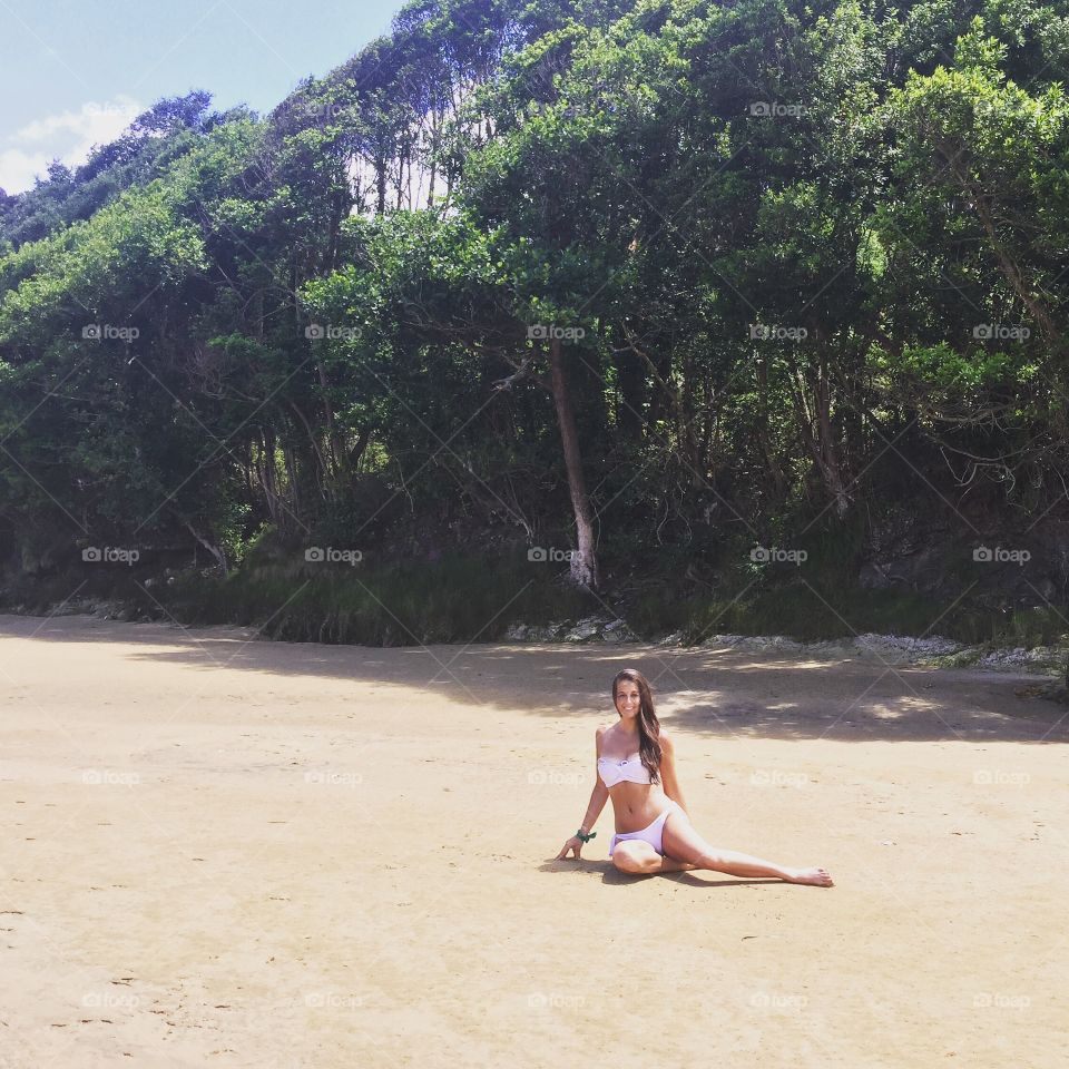 Smiling woman posing at beach