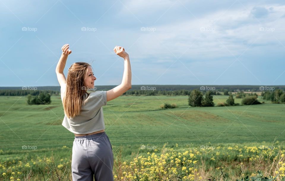 woman relaxes freedom in the field