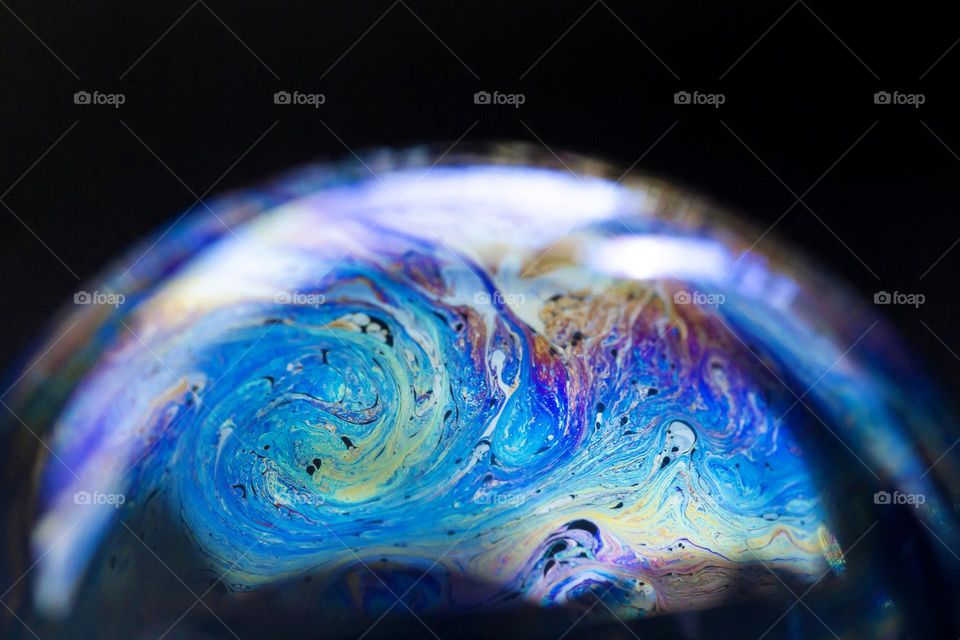 Blue colorful soap bubble, macro closeup