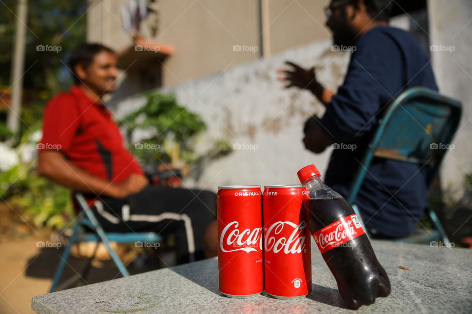 Conversation with friends and having Coca Cola 