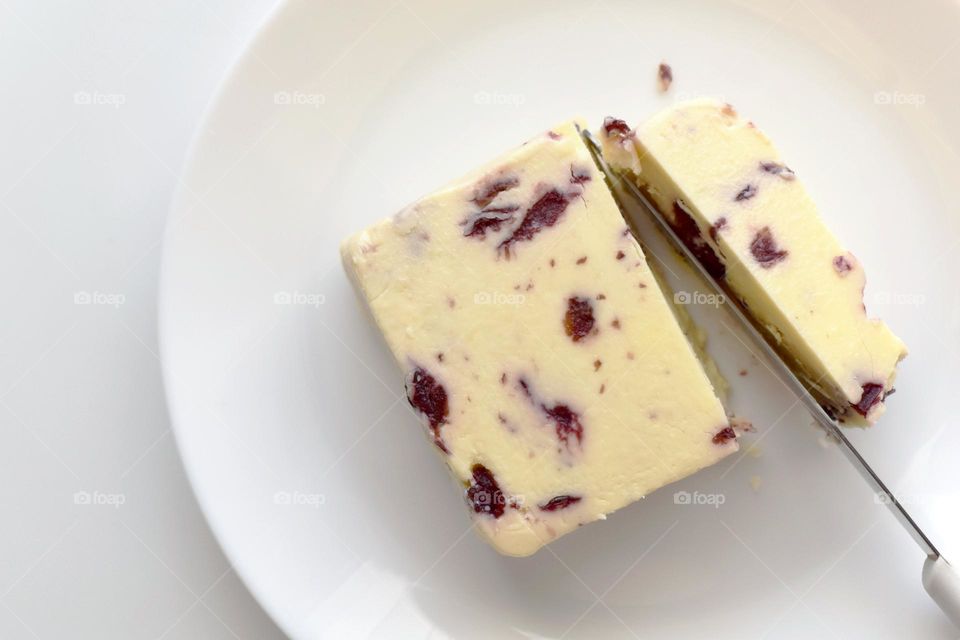 Wensleydale cheese with cranberries on a white plate.