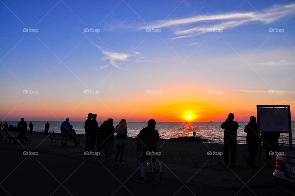 People watching the sunset in Old Skagen in Denmark 