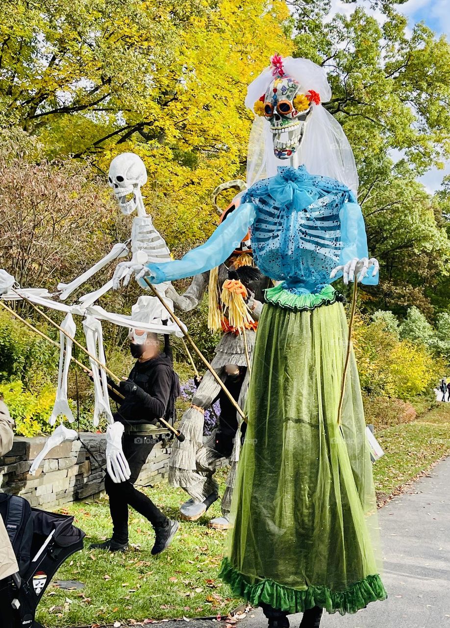 Whimsical Halloween creatures traverse the landscape. 