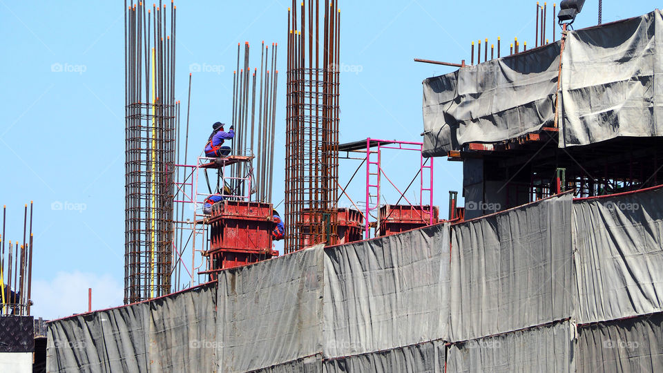 Construction site and workers and steel and concrete material and blue sky