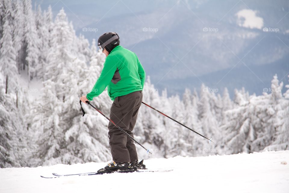 Man skiing in peak Postavarul , Poiana Brasov, Romania 