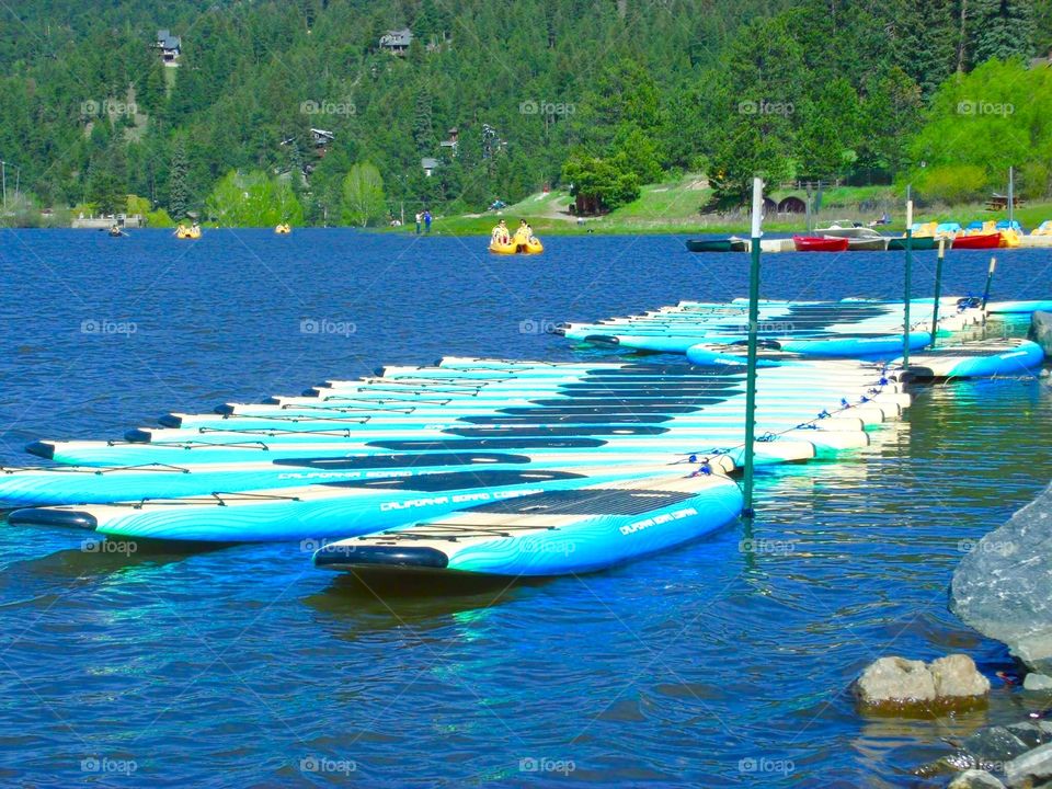 Bright colored  canoes just waiting for passengers at Evergreen Lake, Evergreen, CO.