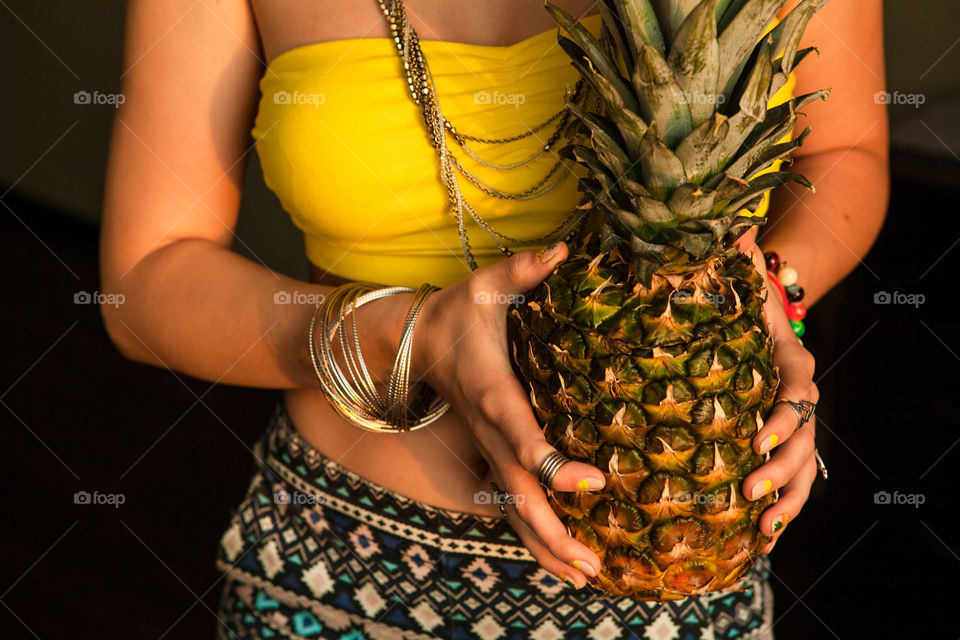 Girl holding pineapple 