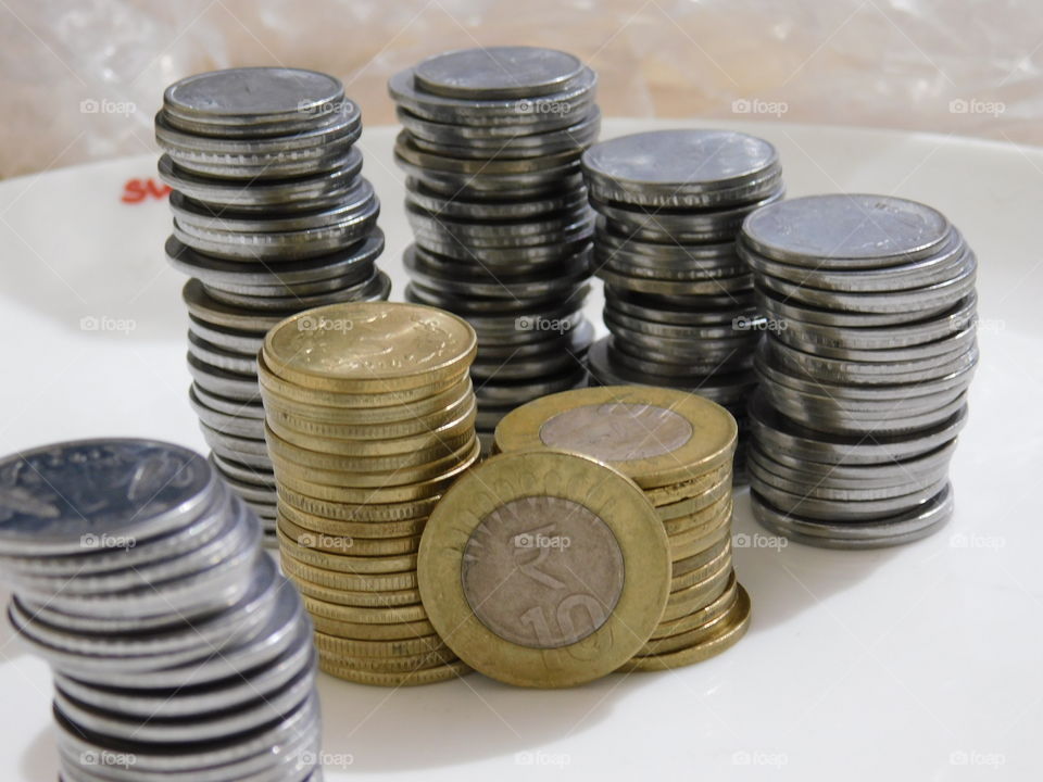 Indian Currency in Rupees - Coins are stacked with definite arrangement.