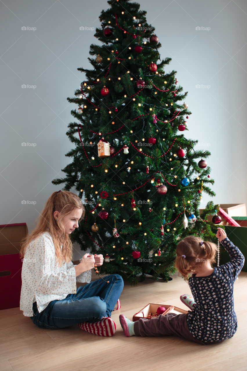 Girls decorating christmas tree