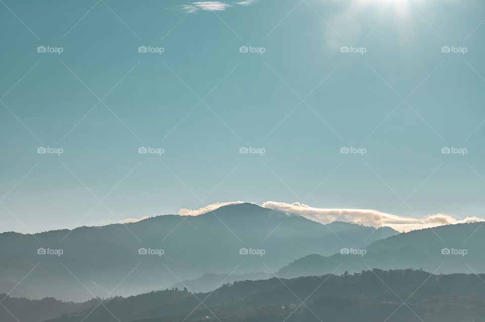 The sunlight shines on the clouds over the mountain ranges of Ukhrul, Manipur, India