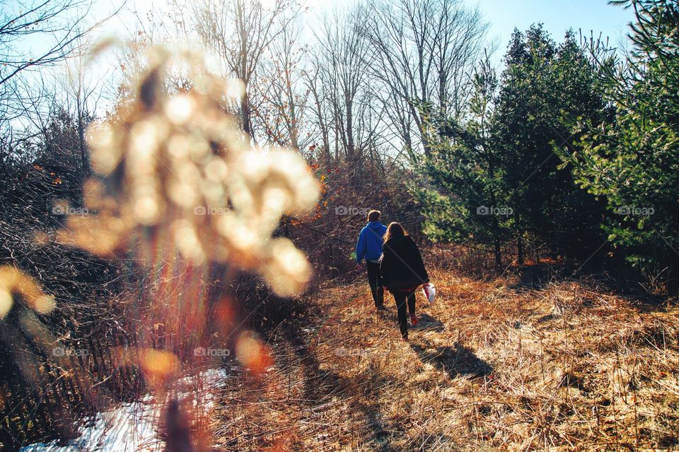 A young couple walking on forest trails