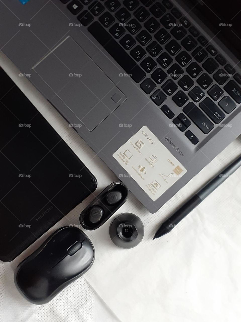 minimalist photo of a designer's desktop with a laptop, mouse, tablet and stylus