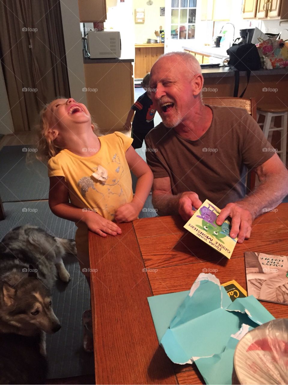 Father and daughter laughing at home