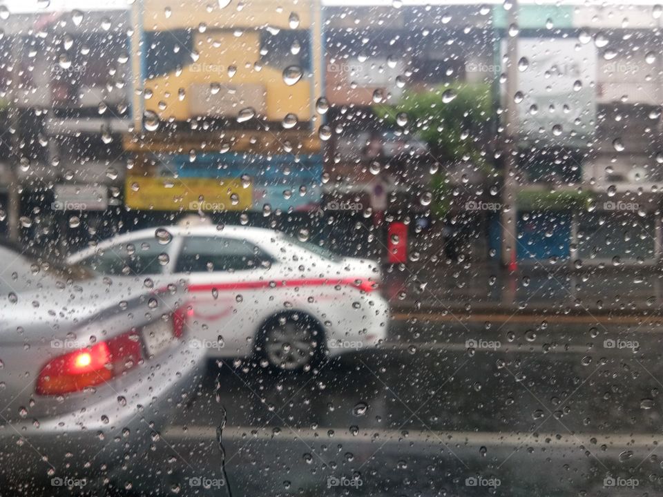 Raining and white taxi