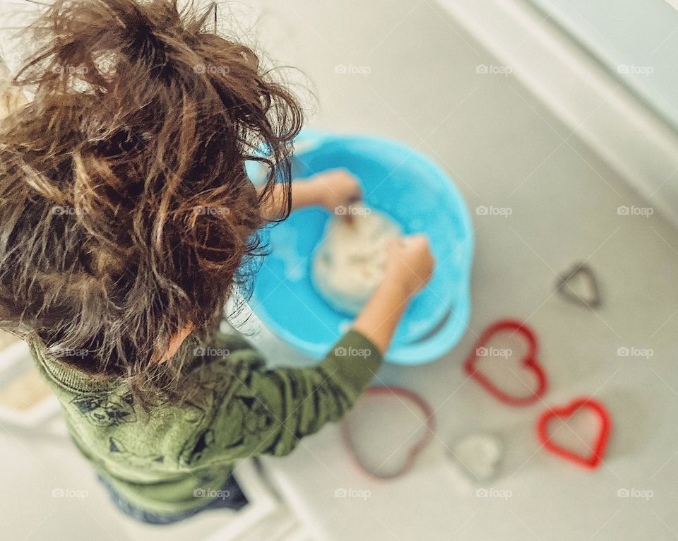 Toddler being creative in the kitchen, toddler making crafts with hearts, salt dough ornaments with a toddler, child making heart decorations, valentines gifts for grandparents, child making crafts with heart cookie cutters