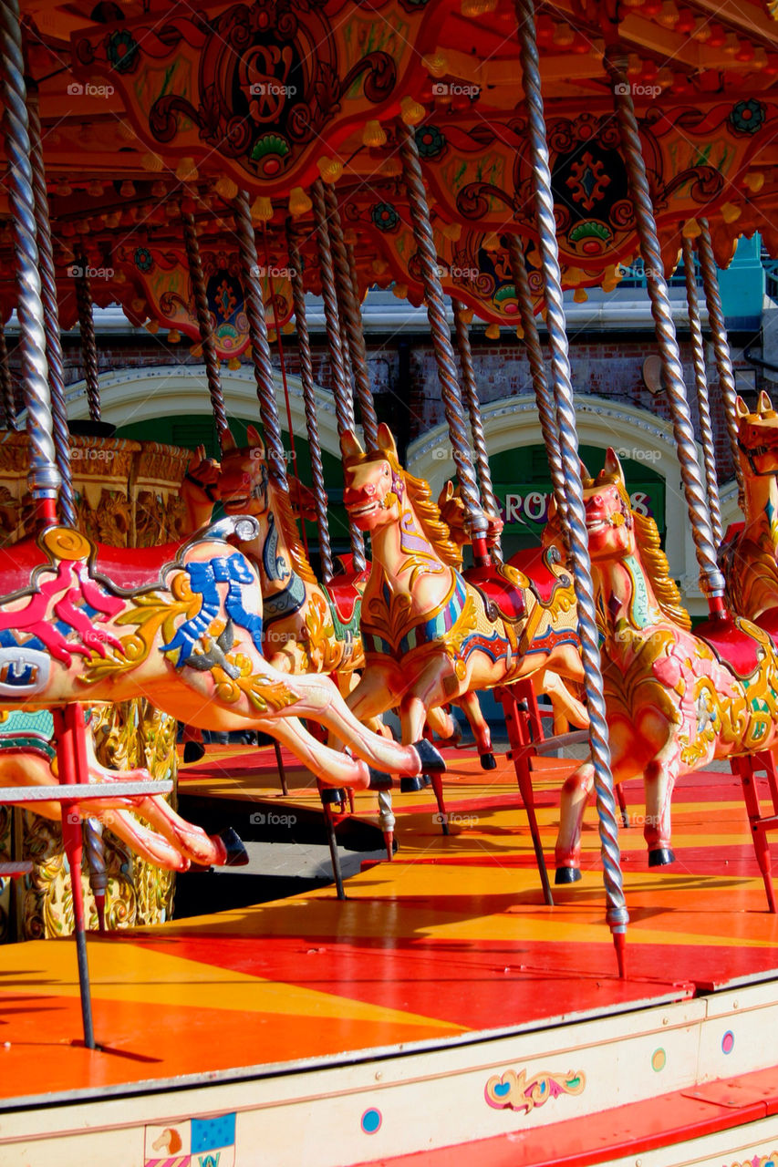 horses colourful carousel round by dannytwotaps