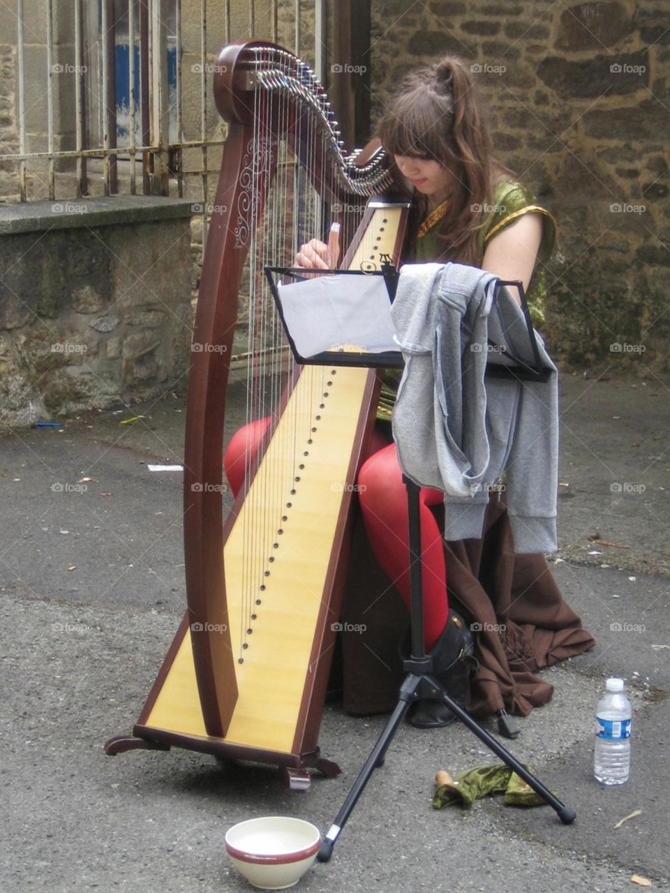 Woman playing harp in the street
