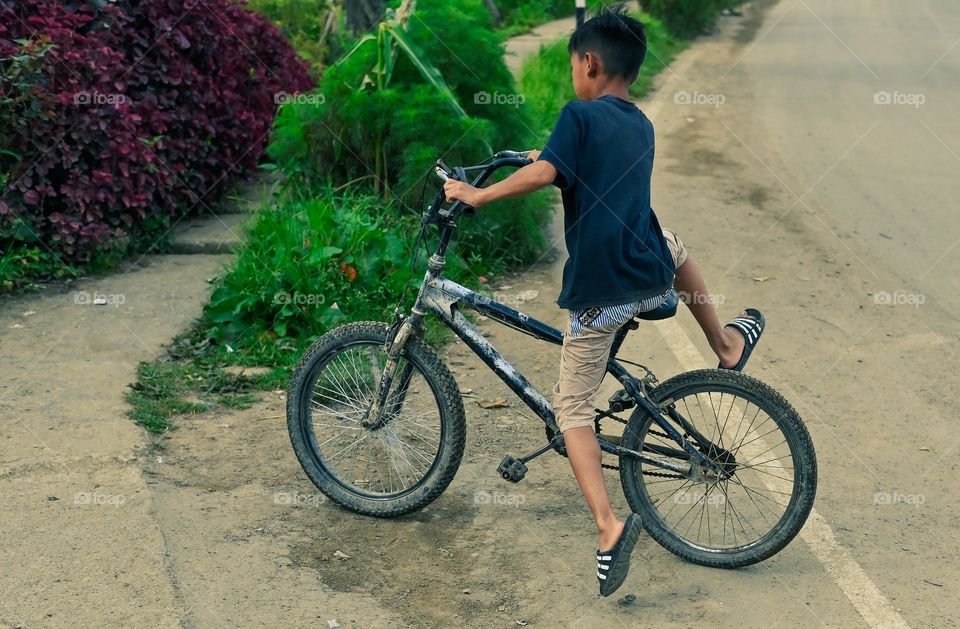 A kid enjoying his all terrain bicycle